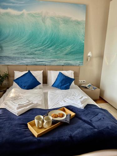 a bed with a tray of food on it at Remora Apartman Balatonszemes in Balatonszemes