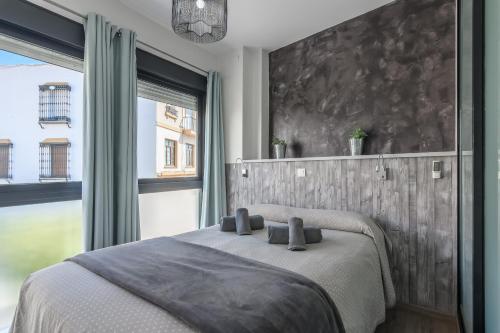 a bedroom with a bed and a large window at River Corner - Centro Ayamonte in Ayamonte