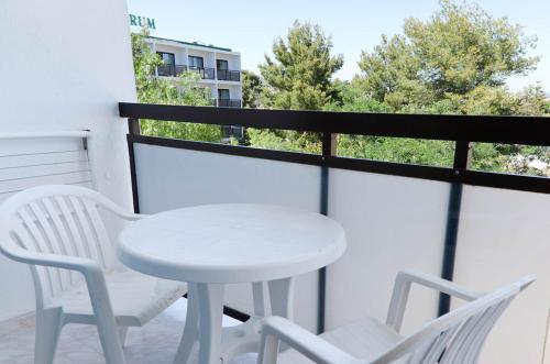 a white table and two chairs on a balcony at Hotel Vibra Mare Nostrum in Playa d'en Bossa