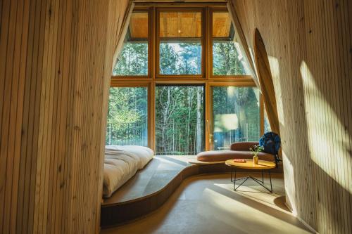 a room with a bed and a large window at SANU 2nd Home 山中湖1st in Yamanakako