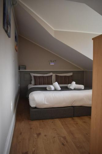 a bedroom with a large bed with two pillows at Alensgrove Maisonette C in Leixlip