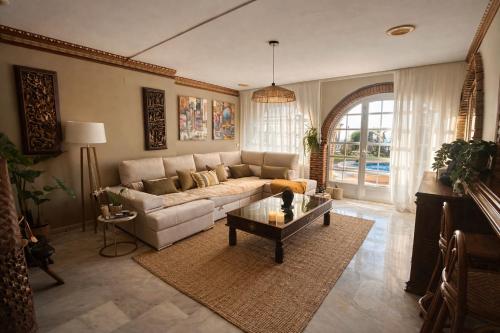 a living room with a couch and a table at Villa Alma Boutique Sea View and Pool adults only in Benalmádena