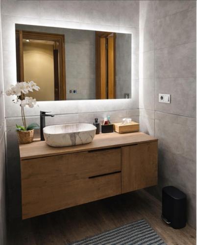 a bathroom with a sink and a large mirror at Villa Alma Boutique Sea View and Pool adults only in Benalmádena
