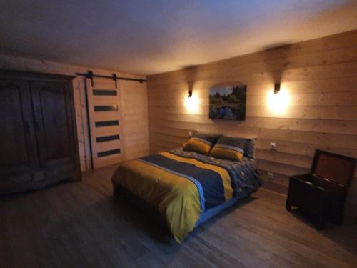 a bedroom with a bed and two pillows on it at La Tanière in Sirod