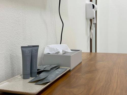 a table with a remote control and a box on it at Wanwichai Room in Ban Lam Ru (1)