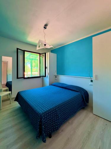 a blue bedroom with a bed in a room at Casa Campanella Resort in Capoliveri