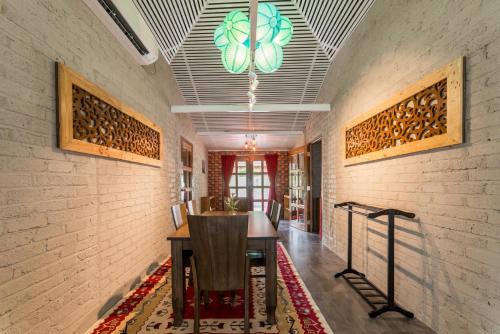 a hallway with a table and a chandelier at The Ocean Residence Langkawi in Kuah