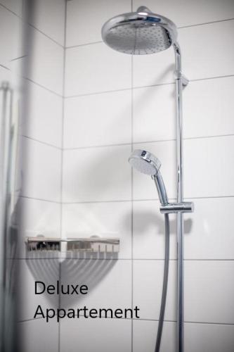a shower in a bathroom with the words deliver agreement at Apartlogie in Tongeren