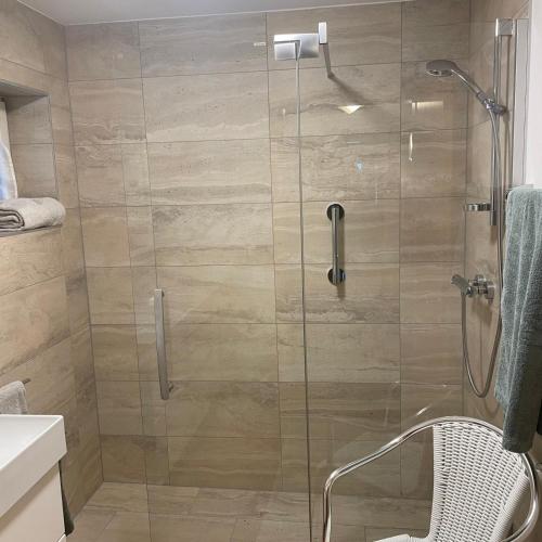 a shower with a glass door in a bathroom at Chalet Milanovic in Dalaas