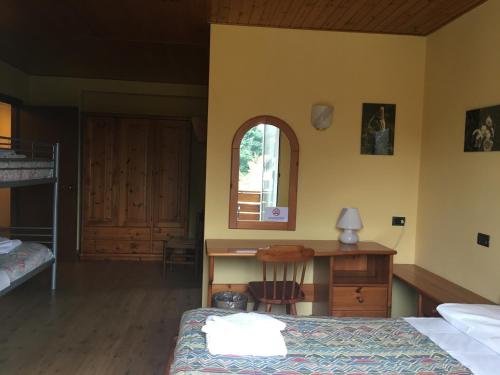 a bedroom with a desk and a bed and a deskicterictericterswersswers at Sporting Club in Ballabio