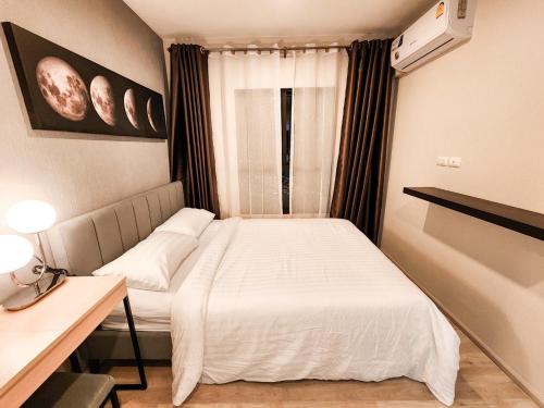 a small bedroom with a bed and a window at Comfy Plum West Gate Condo 1 BR in Ban Bang Krabu