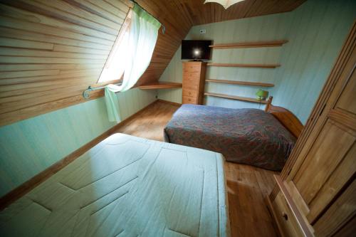 a bedroom with a bed and a window in a room at Les Portes De L'Aubrac in Lacalm