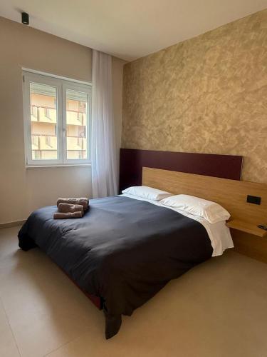 a bedroom with a large bed and a window at La Casa di Hera in Crotone