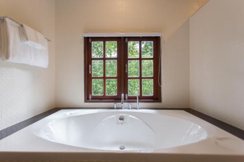 a large white tub in a bathroom with a window at Alisea Pool Villa Aonang in Ao Nang Beach