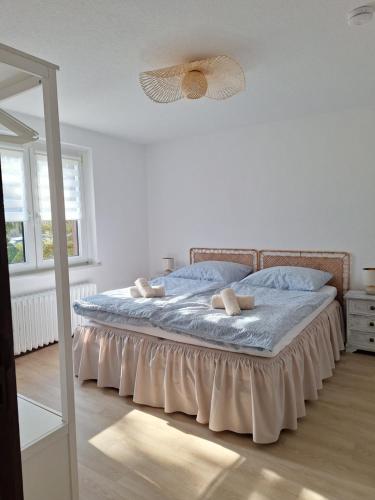a bedroom with a bed with blue sheets and a mirror at Stadt Land Ferienhaus in Falkensee