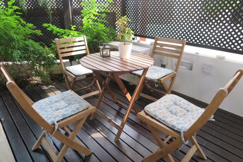 a wooden table and chairs sitting on a deck at Yialos Holiday Apartments in Pervolia