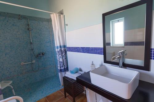 a bathroom with a sink and a shower at Monte Chalaça - Turismo Rural in Ferreira do Alentejo