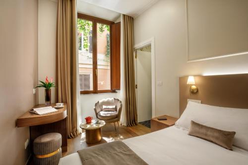 a hotel room with a bed and a desk and a window at Hotel Forte in Rome