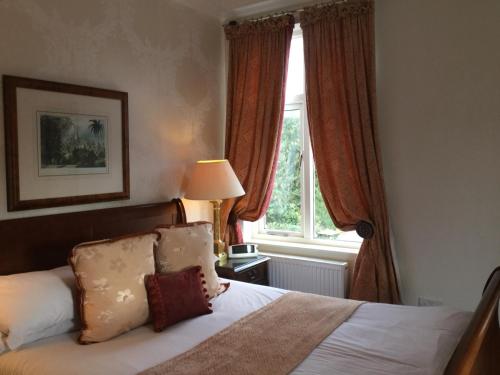 a bedroom with a bed and a window at The Lodge in Kings Lynn