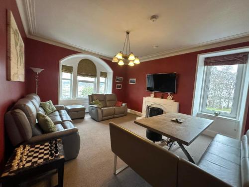 a living room with a couch and a table at Period House Auldcastle Road Crown in Inverness