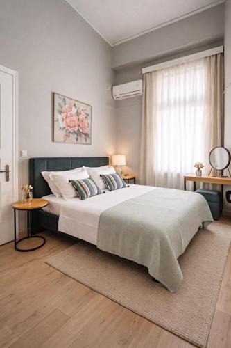 a bedroom with a large bed and a window at Aurora Apartments in Mytilene