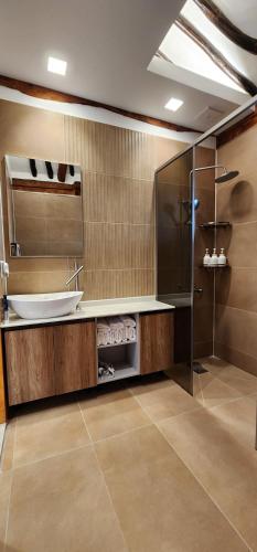 a bathroom with a sink and a glass shower at 전주한옥마을 자하연해랑 in Jeonju