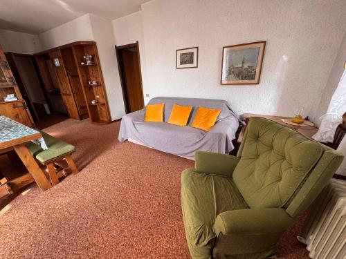 a living room with a couch and a chair at Sweet Peaks in Foppolo