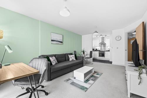 a living room with a couch and a table at Cotels at The HUB Serviced Apartments Fibre WiFi, Central Location in Vibrant Leisure Quarter, Free Parking in Milton Keynes