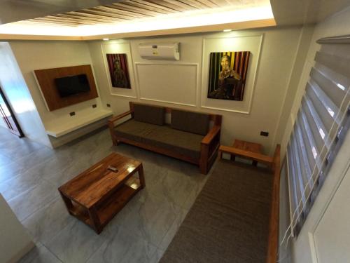a living room with a couch and a table at Annie's Lodge Agoo in Agoo