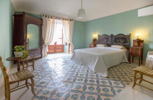 a bedroom with a large bed and a large rug at Villa Palamara 1868-Toweronthesea in SantʼAmbrogio