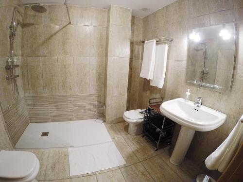 a bathroom with a shower and a sink and a toilet at El Balcón de la Encina in Ponferrada