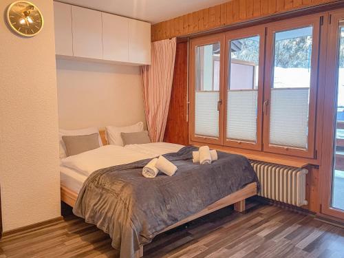 a bedroom with a bed with two towels on it at Nendaz Alpine Studio - Ski & Swimming Pool in Nendaz