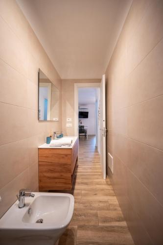 a bathroom with a sink and a mirror at La Dimora del Sole in Monopoli