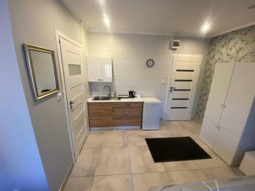 a kitchen with a sink and a white refrigerator at Pokoje na wynajem w Willi in Warsaw