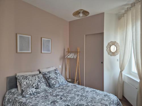 a bedroom with a bed and a window and a fan at St FURSY 2 in Péronne