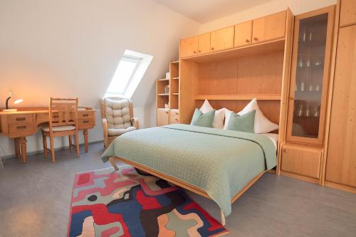 a bedroom with a bed and a desk and a table at Boje 15 in Schillig