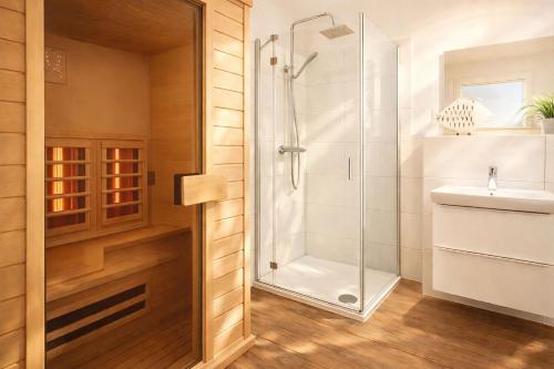 a bathroom with a shower and a sink at Strandnah in Schillig