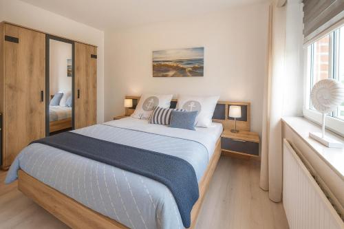 a bedroom with a large bed and a window at Boje 9 in Schillig