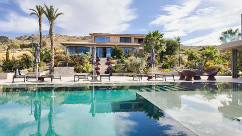 a house with a swimming pool in front of a house at Terreforti Boutique Spa & Glamping in Agrigento