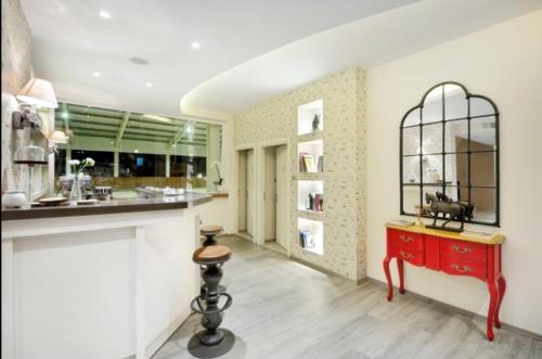 a kitchen with a red counter and a red table at B. Equine Range Hotel in Narlıdere