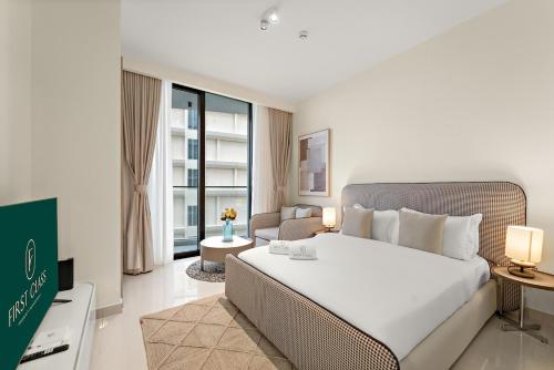 a bedroom with a large bed and a living room at FIRST CLASS Studio Beach View Living Bliss in Ras al Khaimah