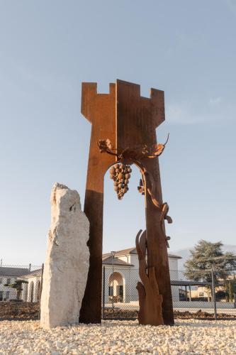 a statue of a person eating grapes from a cross at Casa de Eli - Tenuta Torre Zecchei Wine Experience in Valdobbiadene