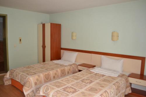 Postel nebo postele na pokoji v ubytování Hotel Perla
