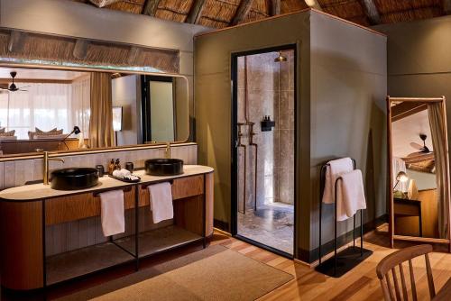 a bathroom with two sinks and a shower at Maasai Wild Adventure in Gatunga