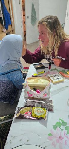 two women are sitting at a table with a table at Dastans Homestay, Bed and Breakfast & Horse riding in Kyzart