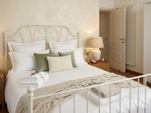 a bedroom with a white bed with white pillows at PIOPPETO OVEST - Premium Villas in Giulianova