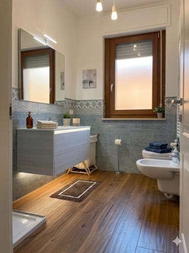 a bathroom with a sink and a toilet and a mirror at PIOPPETO OVEST - Premium Villas in Giulianova