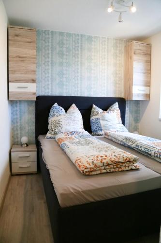 a bedroom with two beds with pillows on them at Ferienbungalow Strandluft in Loissin