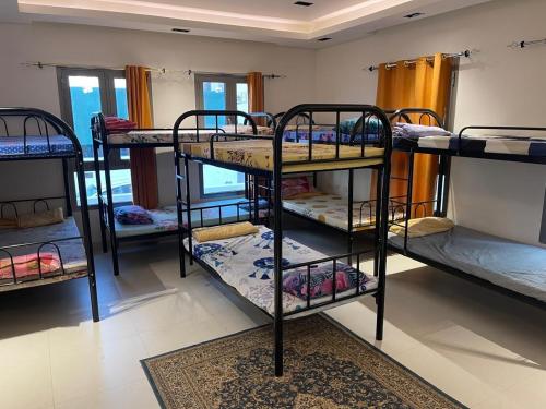 a group of bunk beds in a room at House of Nomads - Hostel in Muscat