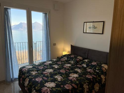 a bedroom with a bed and a window with a view at MyLago in Baveno